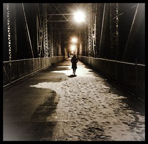 Woman walking on bridge