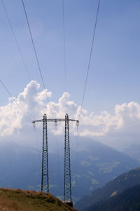 Low angle view of electricity pylon against sky