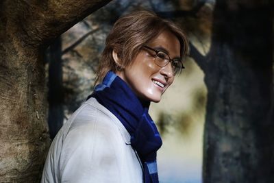 Portrait of smiling young woman standing outdoors