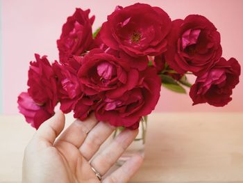 Close-up of hand holding rose bouquet
