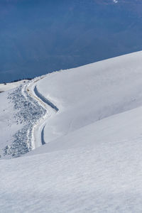 Snow covered mountain against blue sky