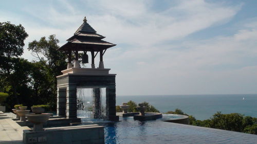 View of building by sea against sky