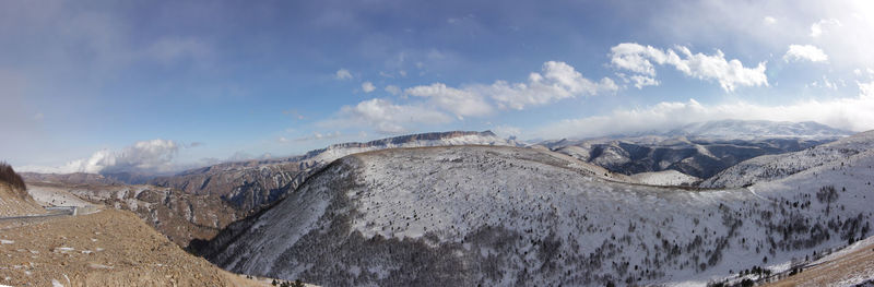 Panoramic view of snowcapped mountains against sky