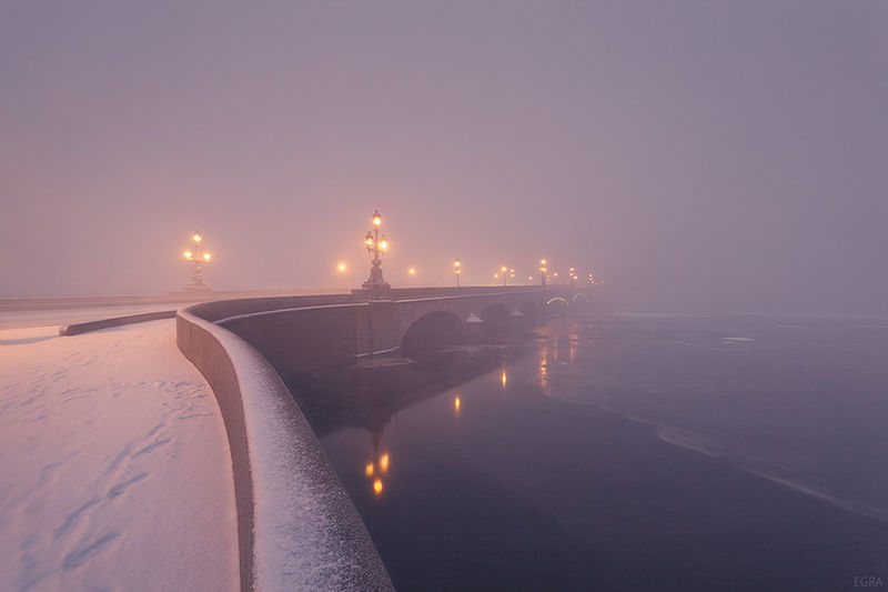 water, sea, clear sky, illuminated, copy space, built structure, sky, tranquility, beach, night, pier, scenics, tranquil scene, nature, reflection, sunset, architecture, connection, transportation, street light