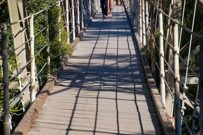 Shadow of person walking on footpath