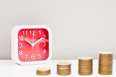 Close-up of coins on table against white background