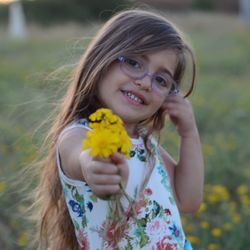 Portrait of cute girl holding flower