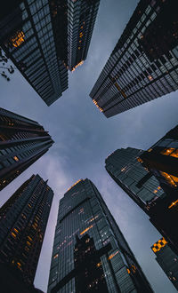 Low angle view of modern buildings against sky at dusk