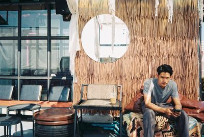 Portrait of young man sitting on chair