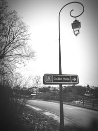 Low angle view of road sign against clear sky