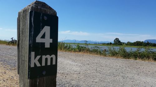 Road sign against blue sky