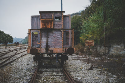 Abandoned freight train against sky