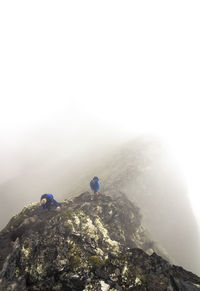 Two people walking on rocky landscape