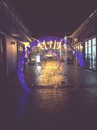 Illuminated christmas lights in city at night