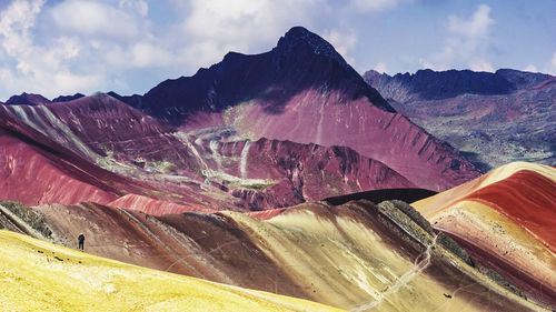 Aerial view of mountain range against cloudy sky