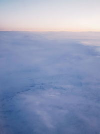 Aerial view of clouds over landscape against sky