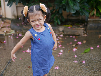 Adorable baby girl, 40 months old, smiling and making cute pose for outdoor photo shoot