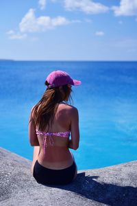 Rear view of woman looking at sea against sky