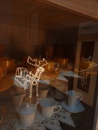 Illuminated candles on table at restaurant