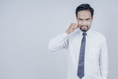 Mid adult man standing against white background