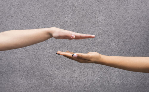 High angle view of hand holding hands on floor