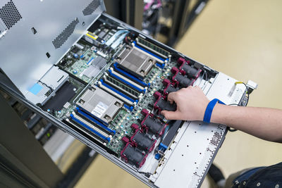 Close-up of teenager working at server