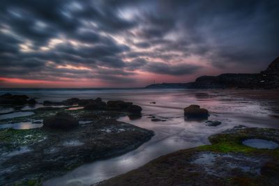 Scenic view of areia branca against cloudy sky during sunset