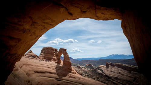 Scenic view of rock formations against cloudy sky