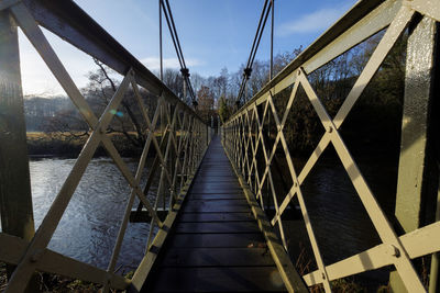 Bridge over footbridge against sky