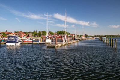 View of marina in sea against sky