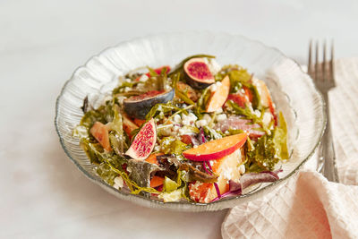 Mediterranean salad with fresh arugula, grain rustic cheese, batata and figs. healthy appetizer