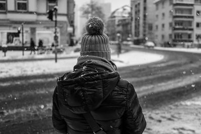 Rear view of woman walking in snow