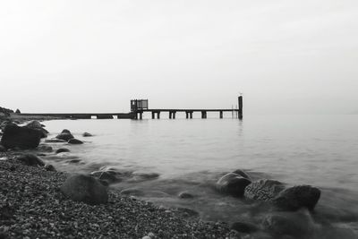 Pier on sea against clear sky