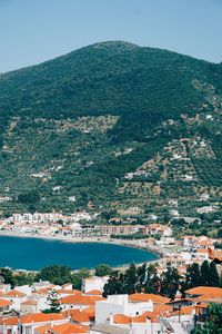 High angle view of townscape by sea against sky