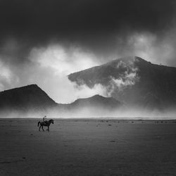 Scenic view of mountain against cloudy sky