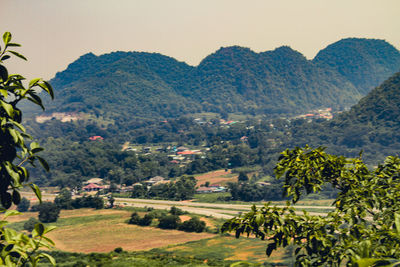 Scenic view of field and mountains against sky