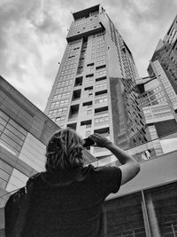 Low angle view of building against cloudy sky