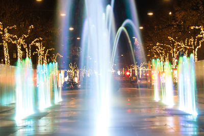 Illuminated city street at night