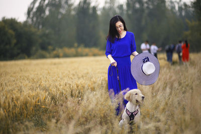 Woman with dog on field