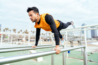 Low angle view of young man exercising in gym