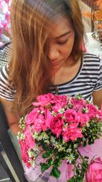 Young woman holding flower