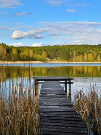 Pier over lake against sky