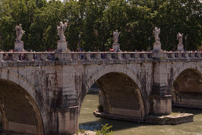 Ponte sant angelo over river against trees