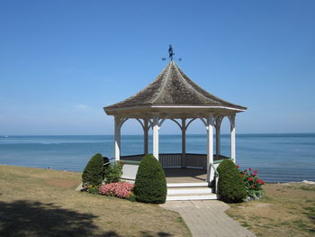 Gazebo at beach against sky