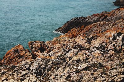 High angle view of rocks on sea shore