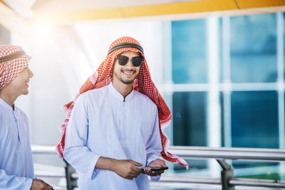 Business colleagues wearing traditional clothing while standing outdoors