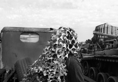 High angle portrait of woman on car against sky