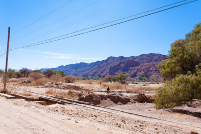 Railroad track amidst mountains against sky