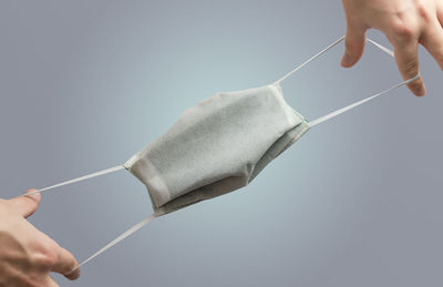 Low angle view of person holding hands over white background