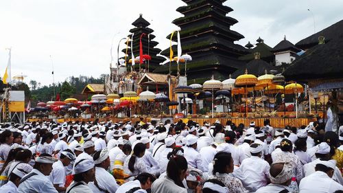 Crowd wearing traditional clothing outside temple